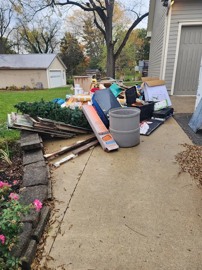 Dumpster being loaded with debris for Roofing Dumpster Rental in Hobart